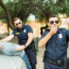 Police officers arresting a man with drugs