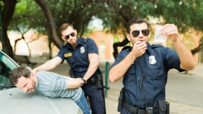 Police officers arresting a man with drugs