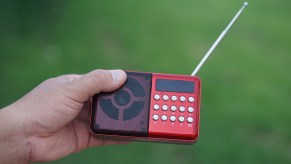 Man holding a radio with an antenna