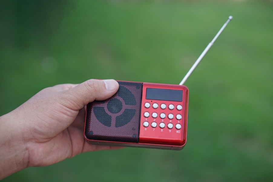 Man holding a radio with an antenna