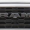 The black RAM logo on the grille of a new pickup truck