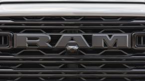 The black RAM logo on the grille of a new pickup truck