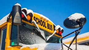 Yellow Colorado school bus covered in snow.