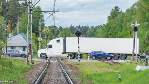 A semi-truck at a railroad crossing