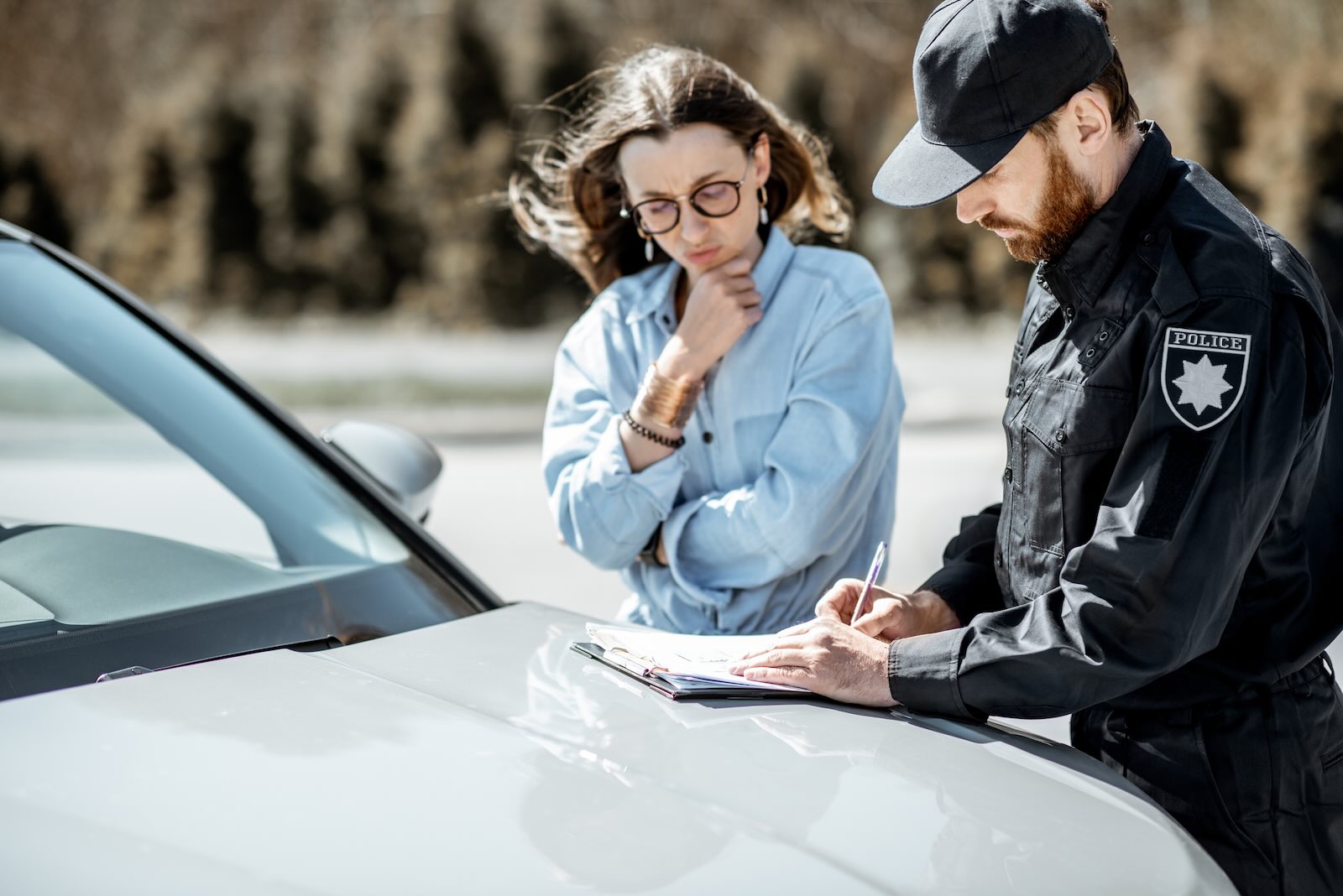 Police officer explains ticket to driver during traffic stop.