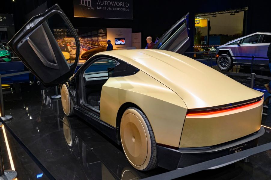 Tesla's scissor door Cybercab prototype on stage at an auto show.