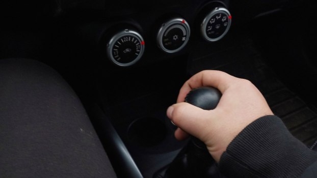 Hand holding a gearshift lever in a manual transmission. Toyota HILux