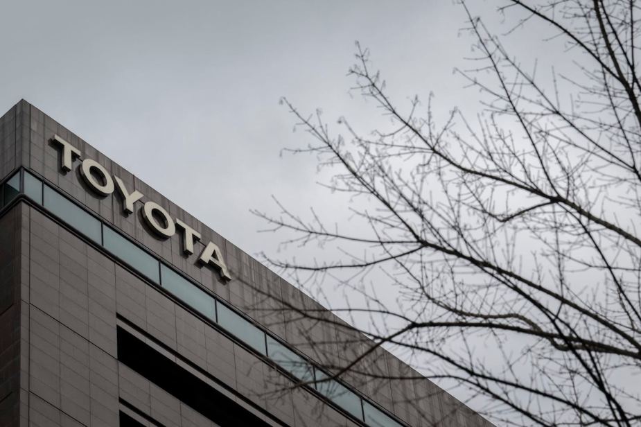 Toyota sign on headquarters building, gray sky in the background.