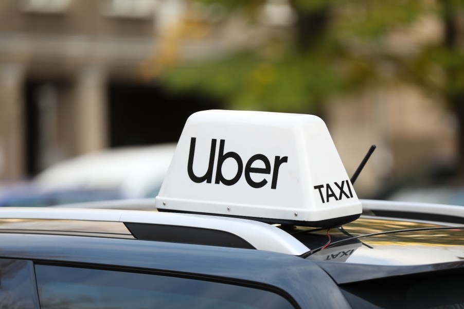 The white Uber Taxi sign on a rideshare car