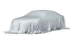 A car fully covered by a white sheet on a white background