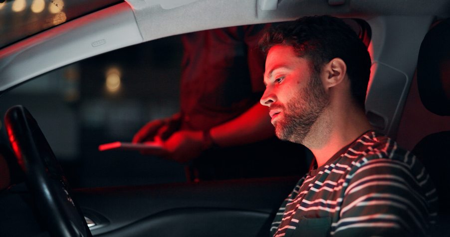 A driver sits while being questioned by police depiction of dui