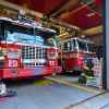 FDNY trucks parked inside fire station view from open doors