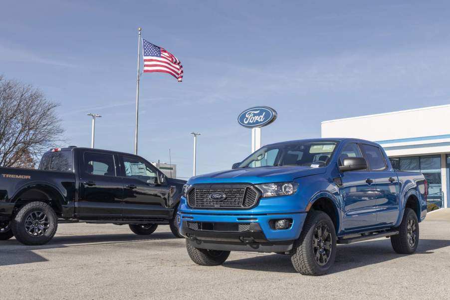 Two Ford trucks parked on dealership lot