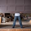 A man lifts a residential garage door from the inside