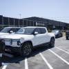 Rivian EVs parked in front of a dealership