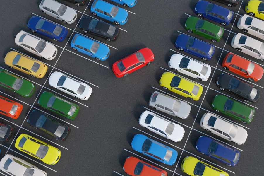 Rows of colorful cars parked in aerial view