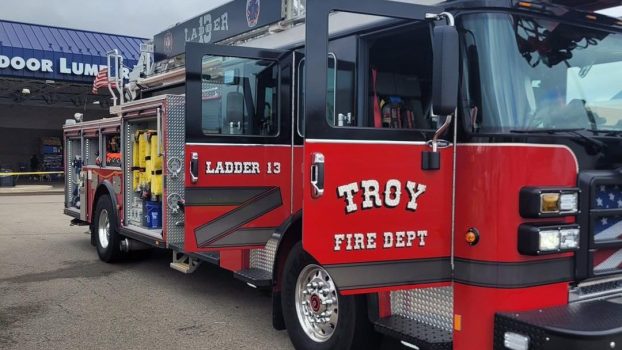 A Troy, Ohio, fire department truck parked in right front angle view with doors open