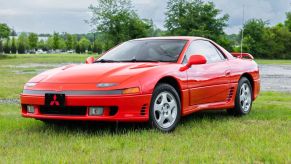 A red 1992 Mitsubishi 3000GT SL parked on grass in left front angle view