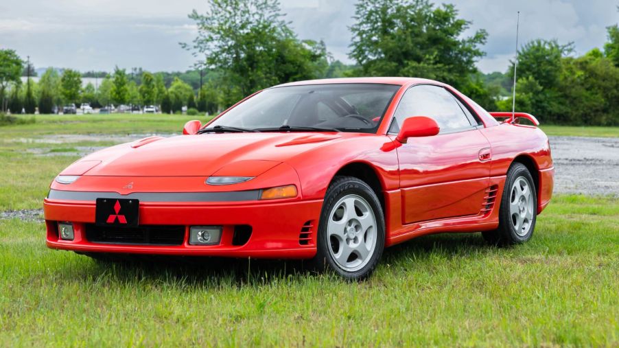 A red 1992 Mitsubishi 3000GT SL parked on grass in left front angle view