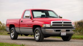 A red 1997 Dodge Ram 1500 Laramie SLT parked in right front angle view