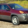 A red 2001 Pontiac Aztek parked in right front angle view