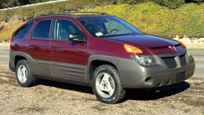 A red 2001 Pontiac Aztek parked in right front angle view