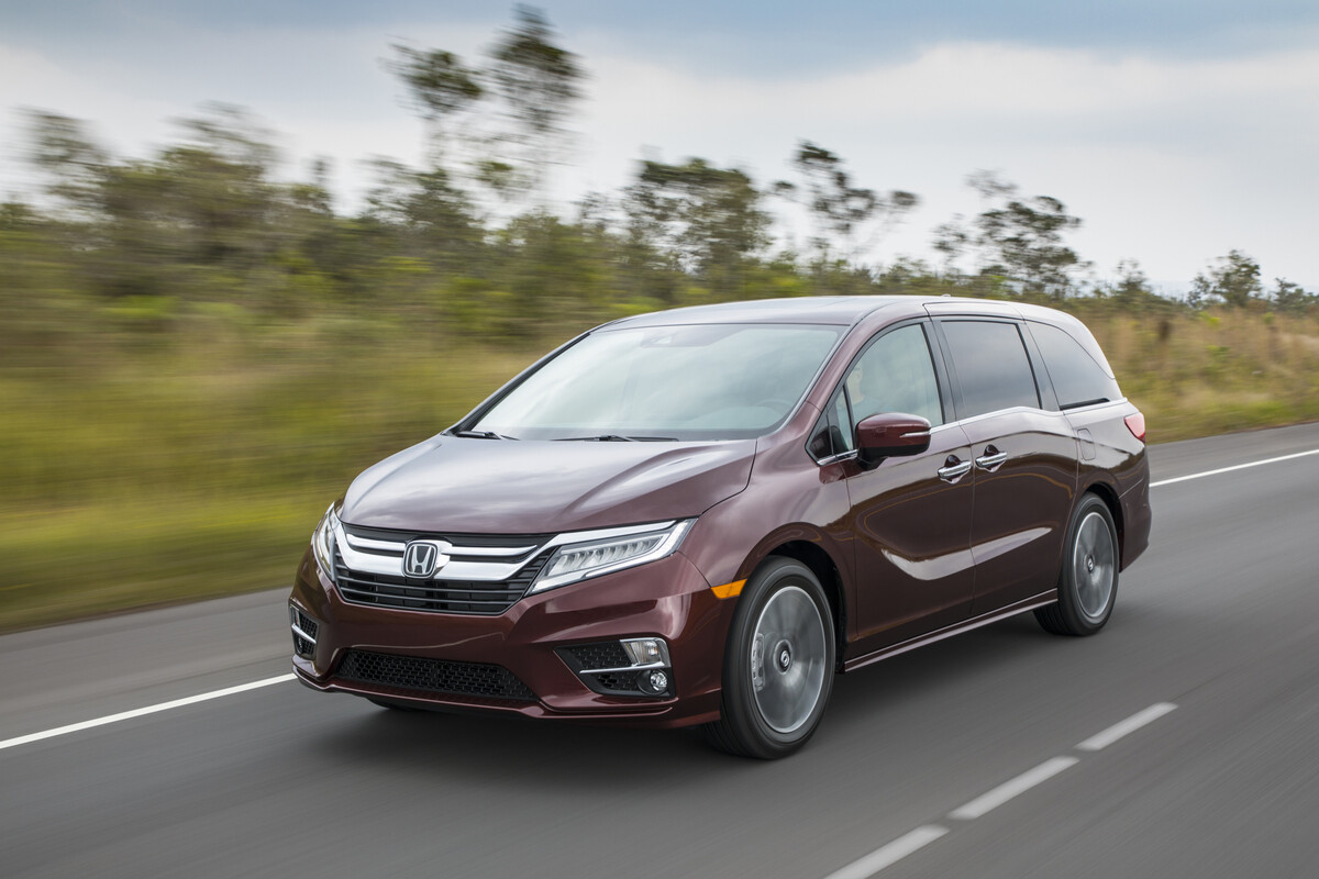 A maroon 2018 Honda Odyssey driving in left front angle view