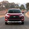 A red 2019 Toyota RAV4 driving in direct front view