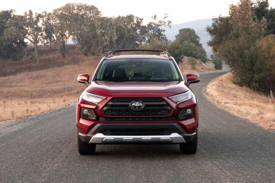 A red 2019 Toyota RAV4 driving in direct front view