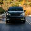 A black 2022 Chrysler Pacifica driving on a highway in direct front view