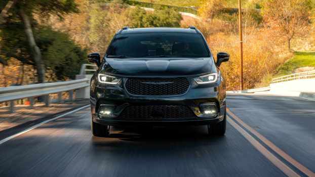 A black 2022 Chrysler Pacifica driving on a highway in direct front view
