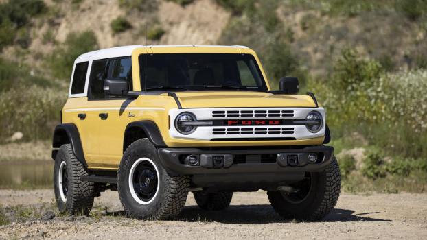 A 2023 Bronco Heritage Limited Edition in Yellowstone Metallic parked outside in right front angle view