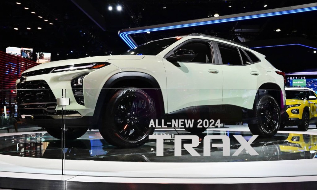 White Chevrolet Trax Crossover SUV on the stage at a car show.