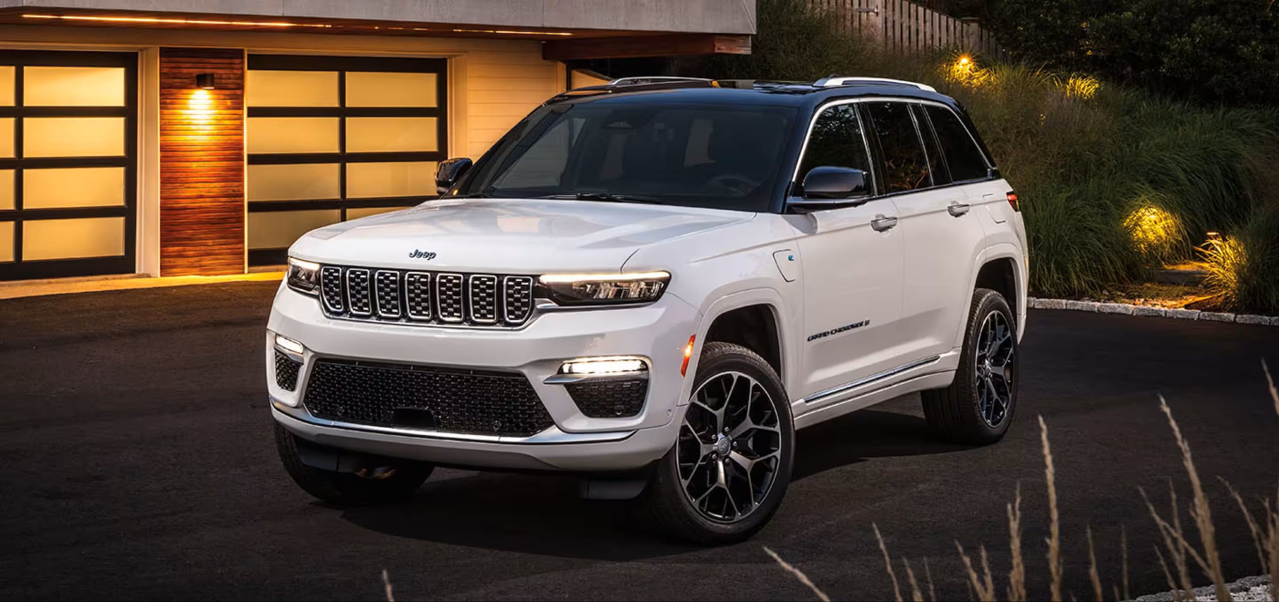 The 2026 Jeep Grand Cherokee near a home