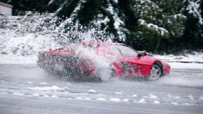 Red 2WD Ferrari drifts through the snow