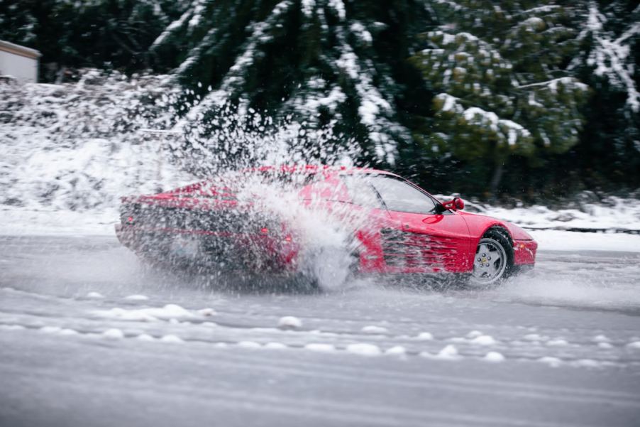 Red 2WD Ferrari drifts through the snow