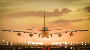 Airplane flying just above runway at airport, moments before landing