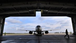 Silhouette of a Boeing 737 jet airplane entering a hanger