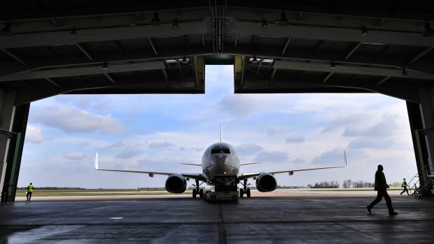 Silhouette of a Boeing 737 jet airplane entering a hanger