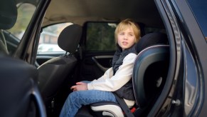 A kid in a car booster seat