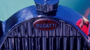 The chrome grille on a vintage Bugatti car at a show.