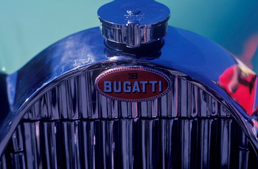 The chrome grille on a vintage Bugatti car at a show.