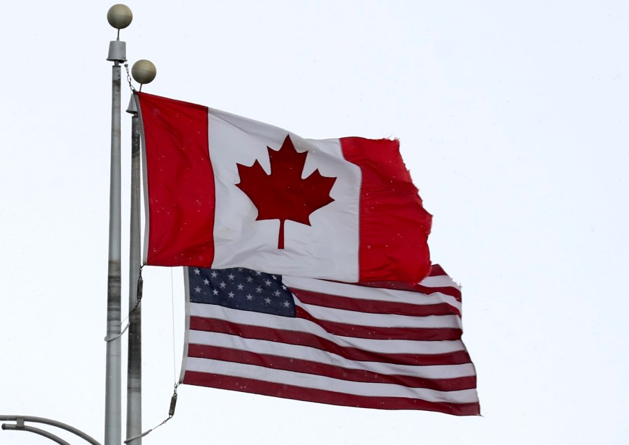 The Canadian and U.S. flag fly side-by-side.