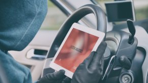 Car thief uses an electronic device to program a new key and steal a Camaro