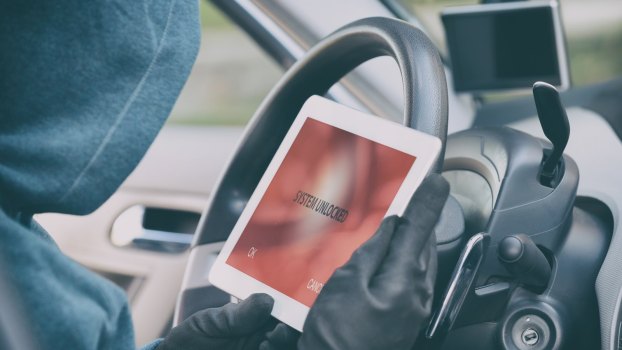 Car thief uses an electronic device to program a new key and steal a Camaro