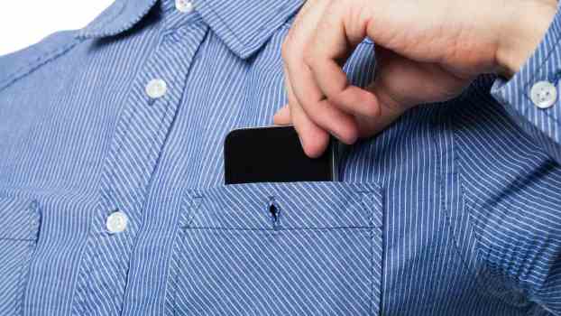 Driver tucks cellphone into a shirt pocket to secretly record the police during a traffic stop.