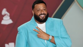 DJ Khaled on stage in a turquoise blazer.