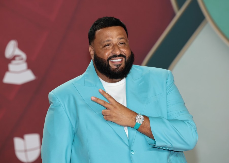 DJ Khaled on stage in a turquoise blazer.