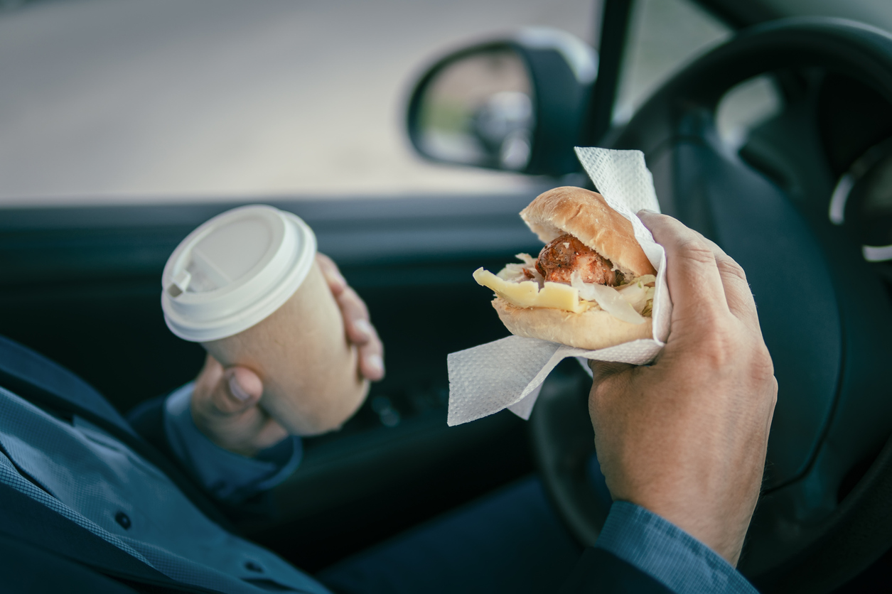 A man driving while eating