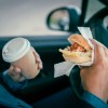 A man driving while eating